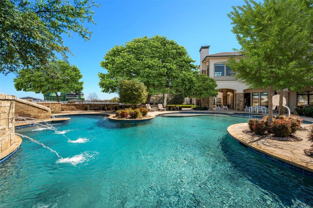 940 Dove Road Southlake, TX 76092 - Photo 29 of 34 a house with swimming pool and trees in the background