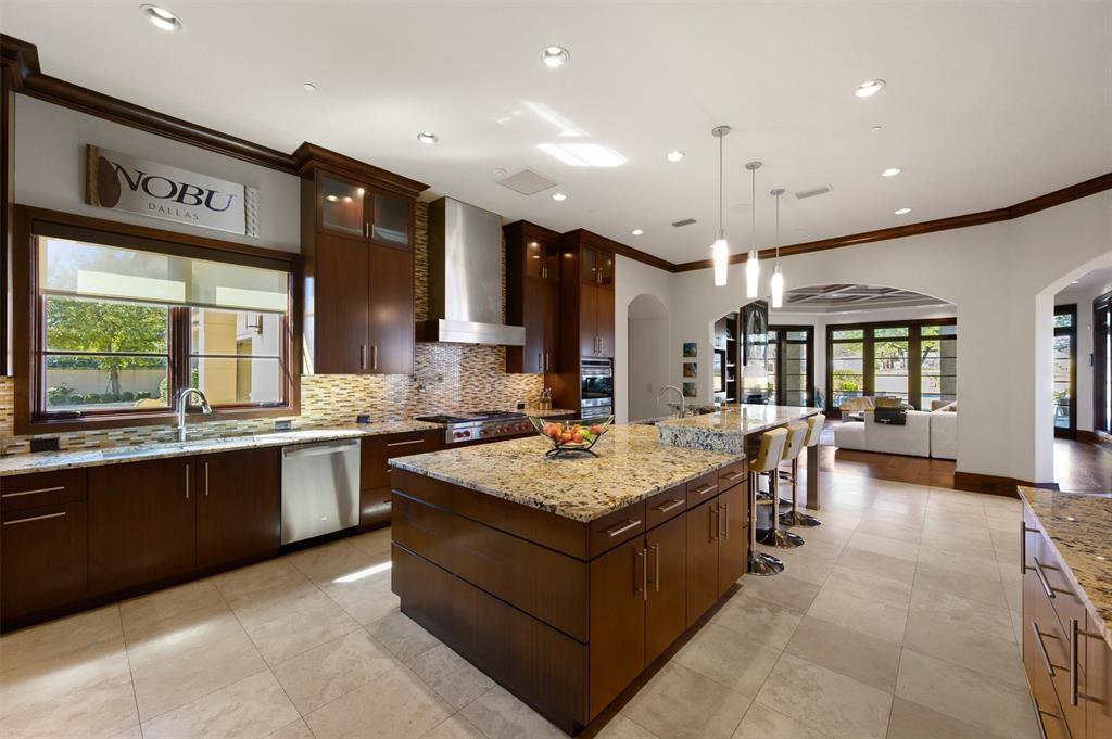 940 Dove Road Southlake, TX 76092 - Photo 8 of 34 a large kitchen with a large counter top space a sink stainless steel appliances and cabinets