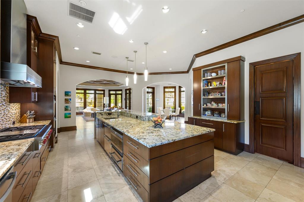 940 Dove Road Southlake, TX 76092 - Photo 10 of 34 a large kitchen with stainless steel appliances granite countertop a large counter top and stove