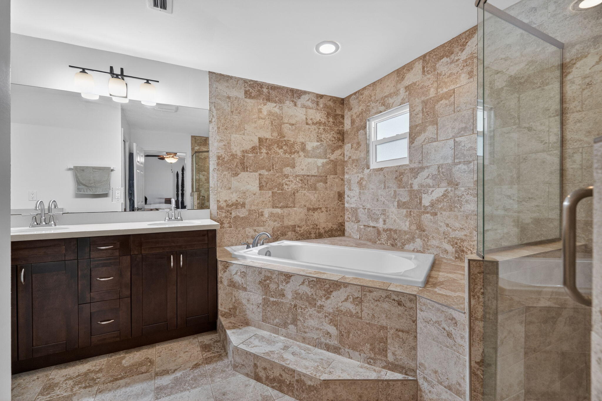 17391 Alexander Run Jupiter, FL 33478 - Photo 16 of 55 a spacious bathroom with a double vanity sink a mirror and a shower