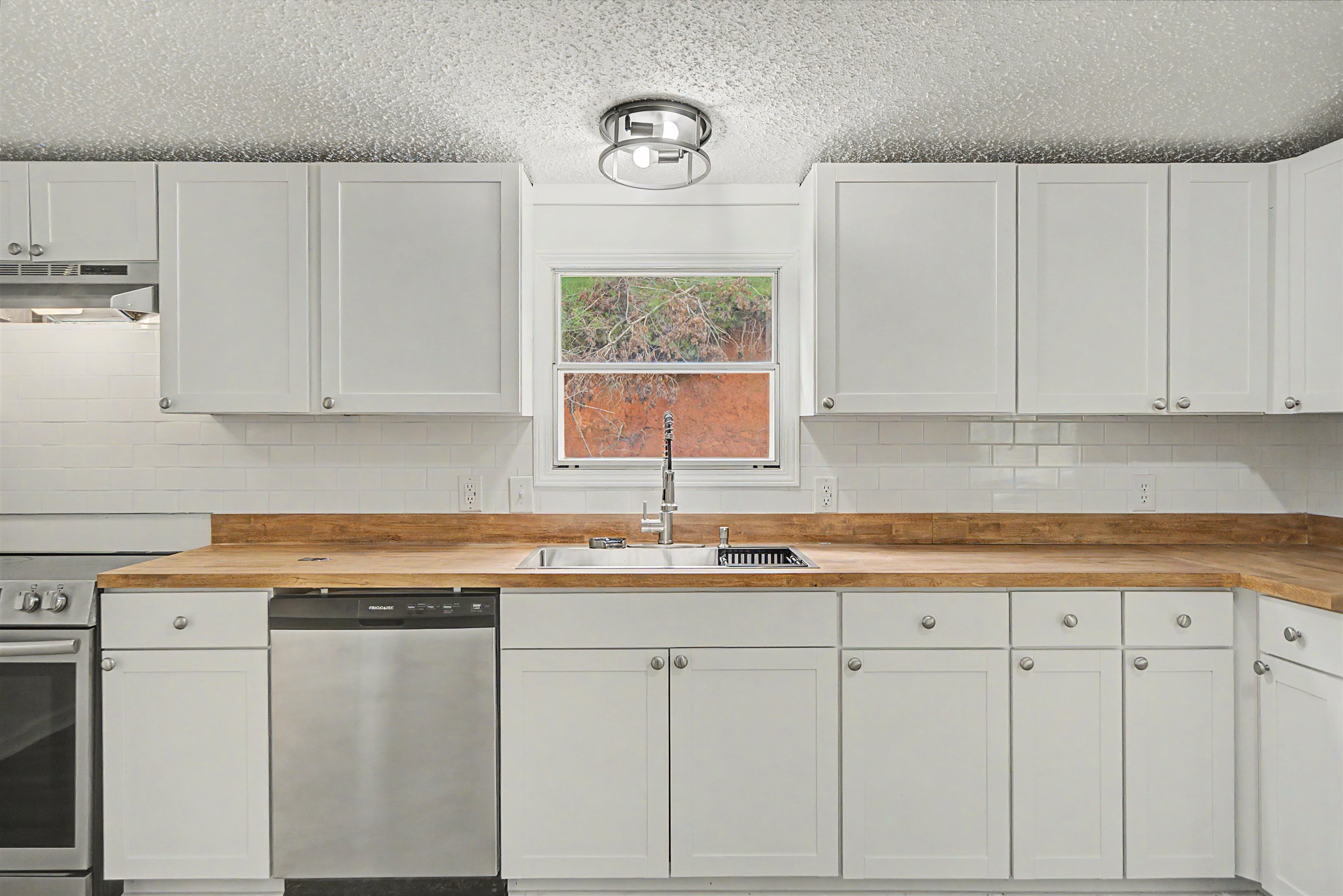 890 Burks Road Savannah, TN 38372 - Photo 11 of 40 a kitchen with white cabinets and white appliances