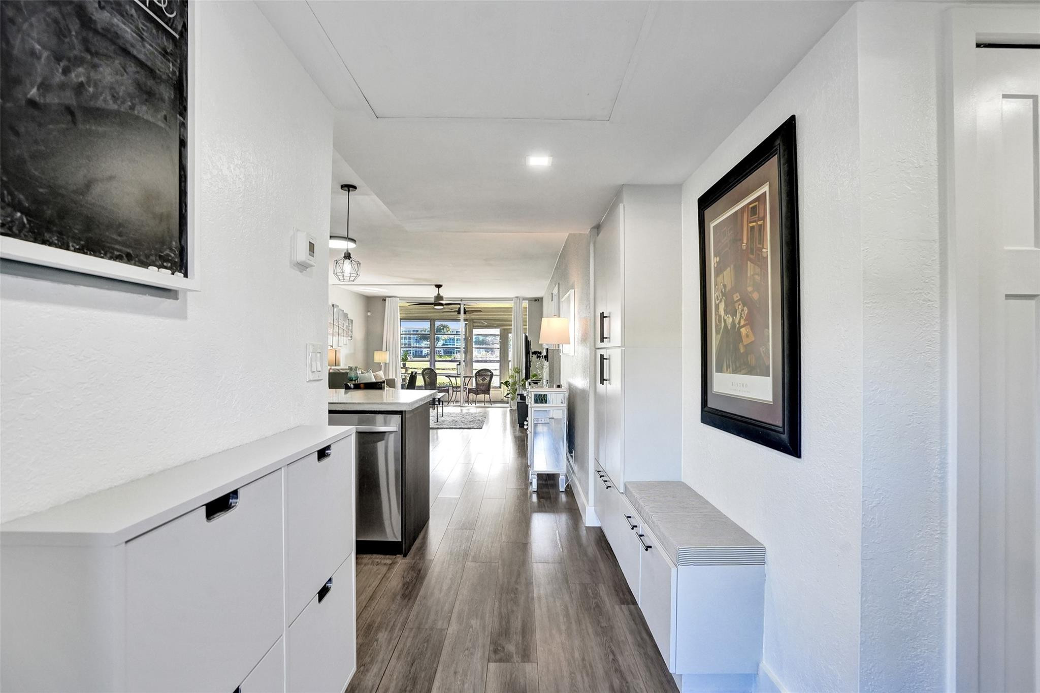 3001 South Course Drive, Unit 107 Pompano Beach, FL 33069 - Photo 13 of 47 a kitchen with stainless steel appliances granite countertop a refrigerator a stove and a wooden floors