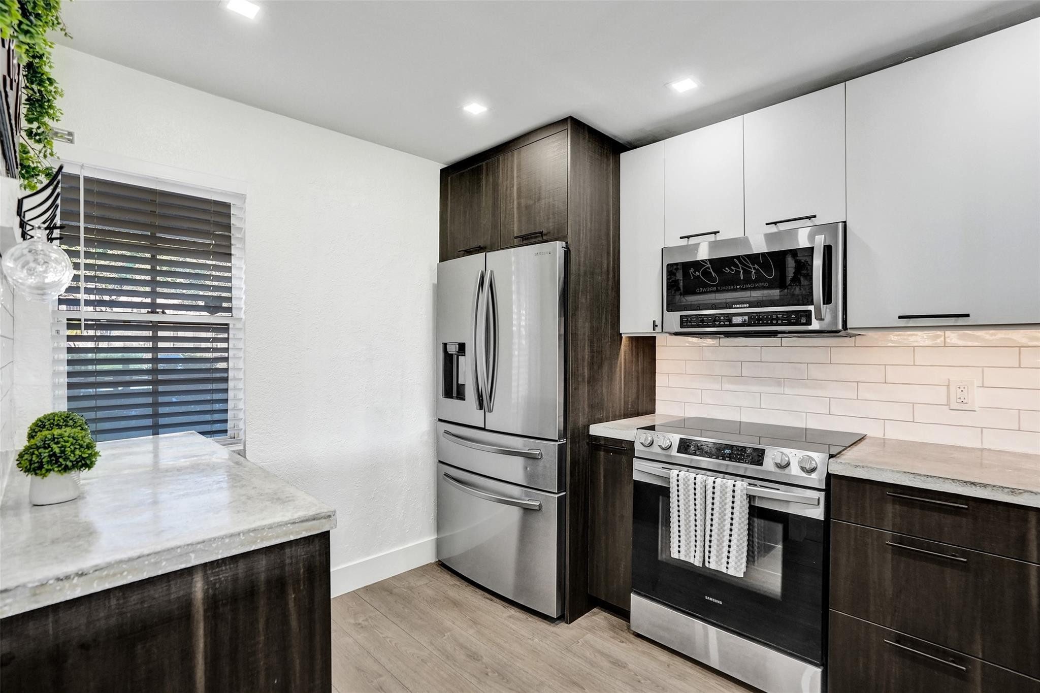 3001 South Course Drive, Unit 107 Pompano Beach, FL 33069 - Photo 14 of 47 a kitchen with stainless steel appliances a stove microwave and refrigerator