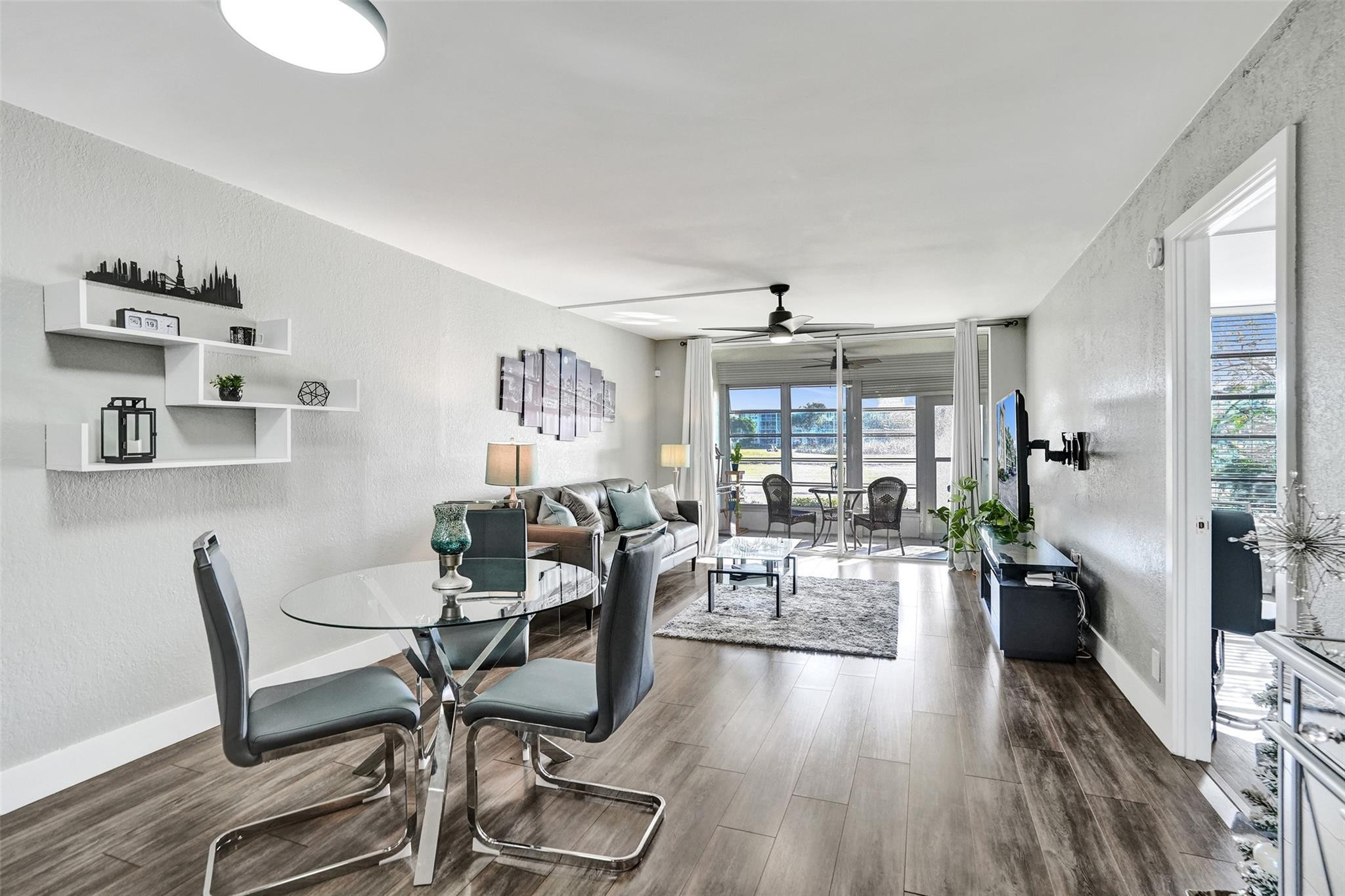3001 South Course Drive, Unit 107 Pompano Beach, FL 33069 - Photo 19 of 47 a living room with furniture and a wooden floor