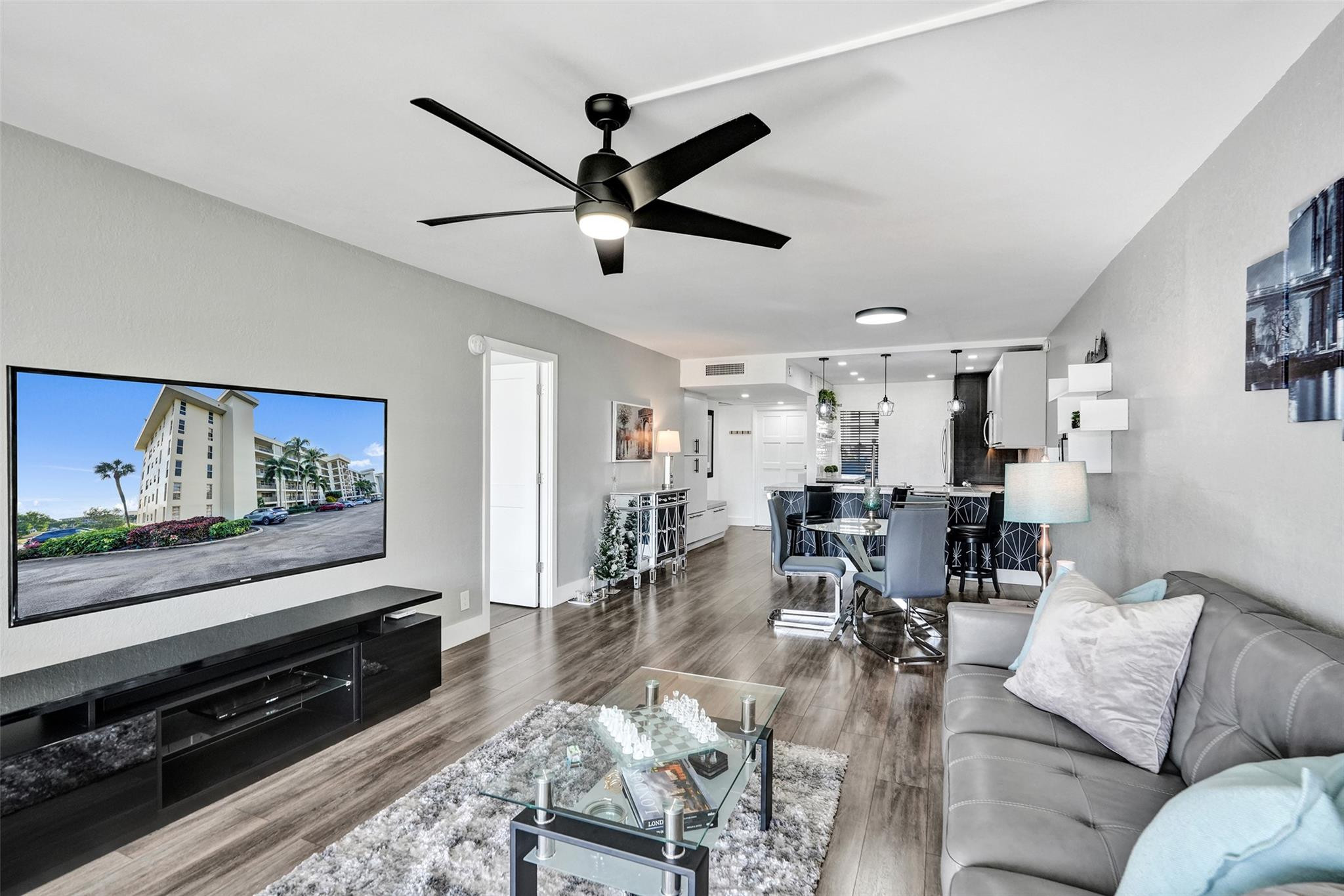 3001 South Course Drive, Unit 107 Pompano Beach, FL 33069 - Photo 22 of 47 a living room with furniture and a flat screen tv