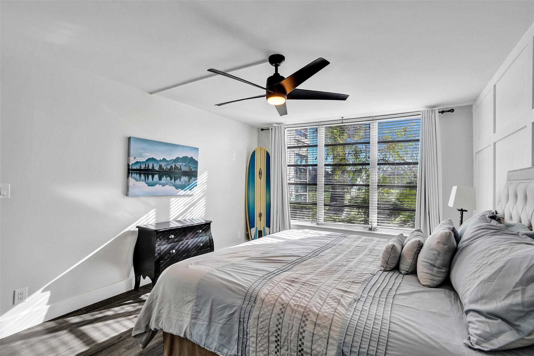 3001 South Course Drive, Unit 107 Pompano Beach, FL 33069 - Photo 26 of 47 a bedroom with a bed painting on wall and a large window