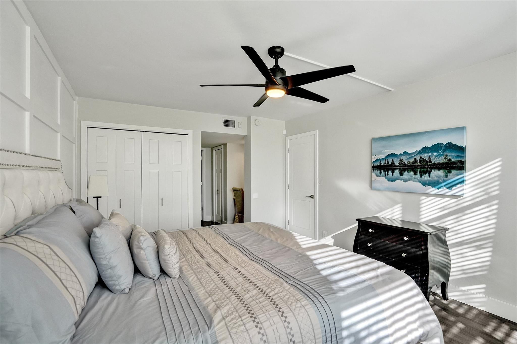 3001 South Course Drive, Unit 107 Pompano Beach, FL 33069 - Photo 28 of 47 a bedroom with a bed and a chandelier