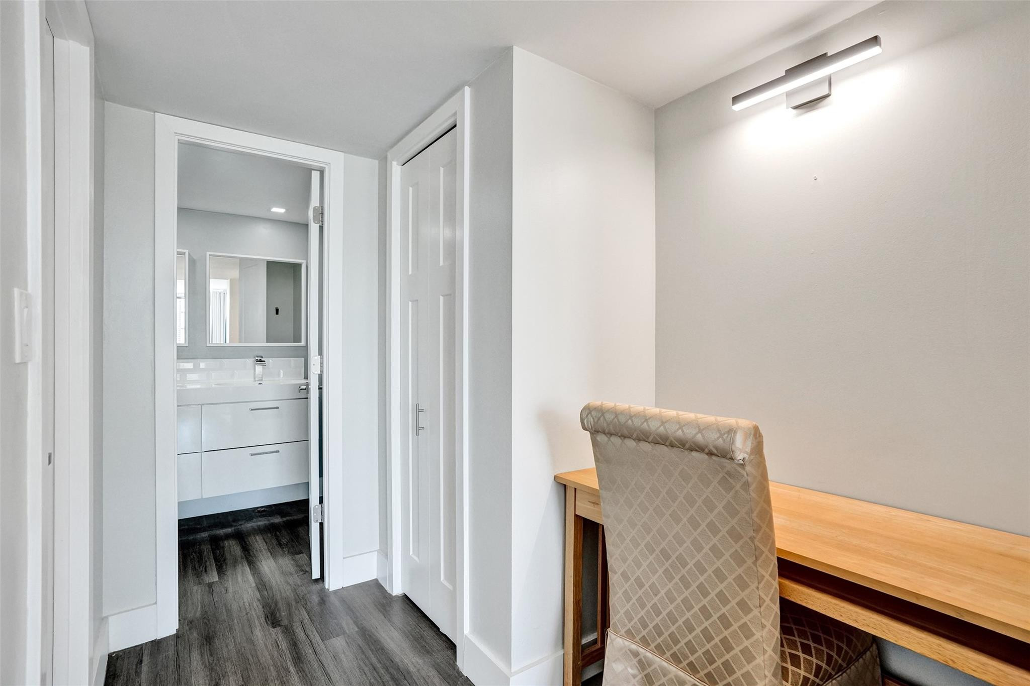 3001 South Course Drive, Unit 107 Pompano Beach, FL 33069 - Photo 29 of 47 a view of an empty room and wooden floor