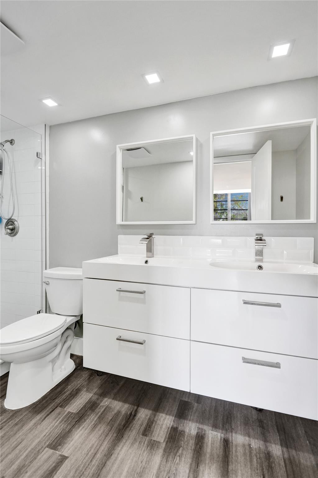 3001 South Course Drive, Unit 107 Pompano Beach, FL 33069 - Photo 32 of 47 a bathroom with a double vanity sink toilet and a mirror