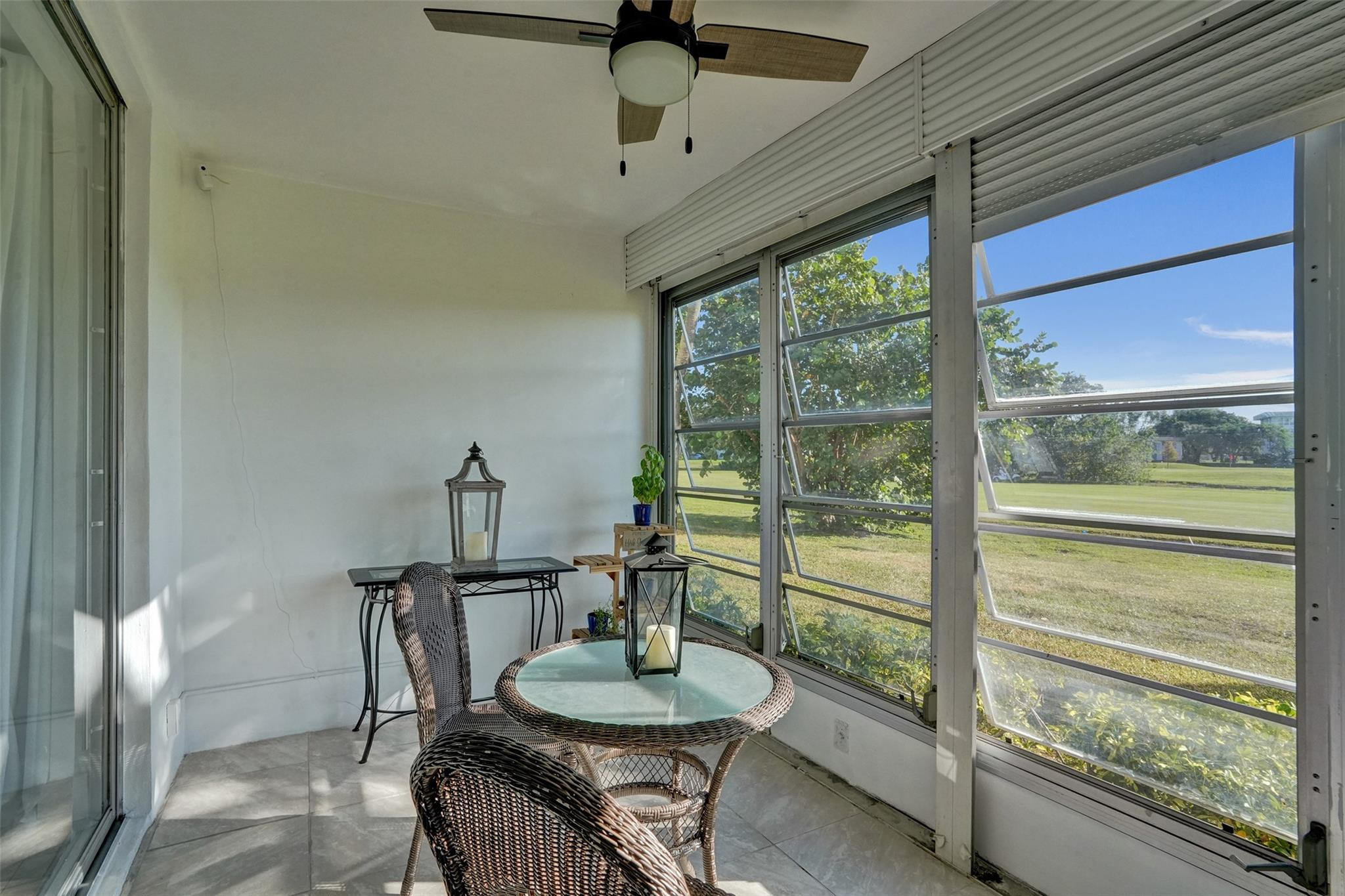 3001 South Course Drive, Unit 107 Pompano Beach, FL 33069 - Photo 35 of 47 a dining room with furniture and a floor to ceiling window