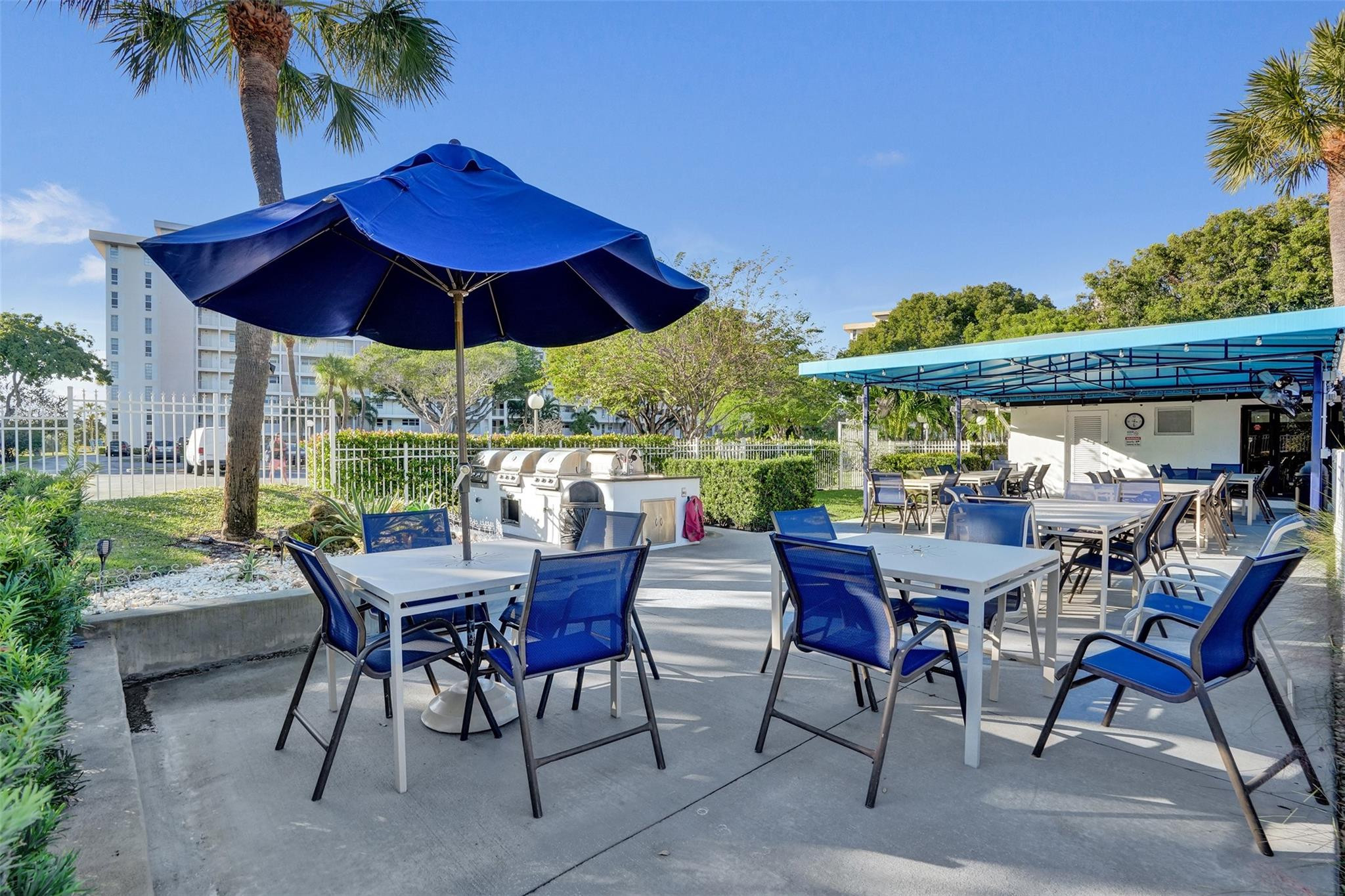 3001 South Course Drive, Unit 107 Pompano Beach, FL 33069 - Photo 37 of 47 a view of a patio with furniture and a yard