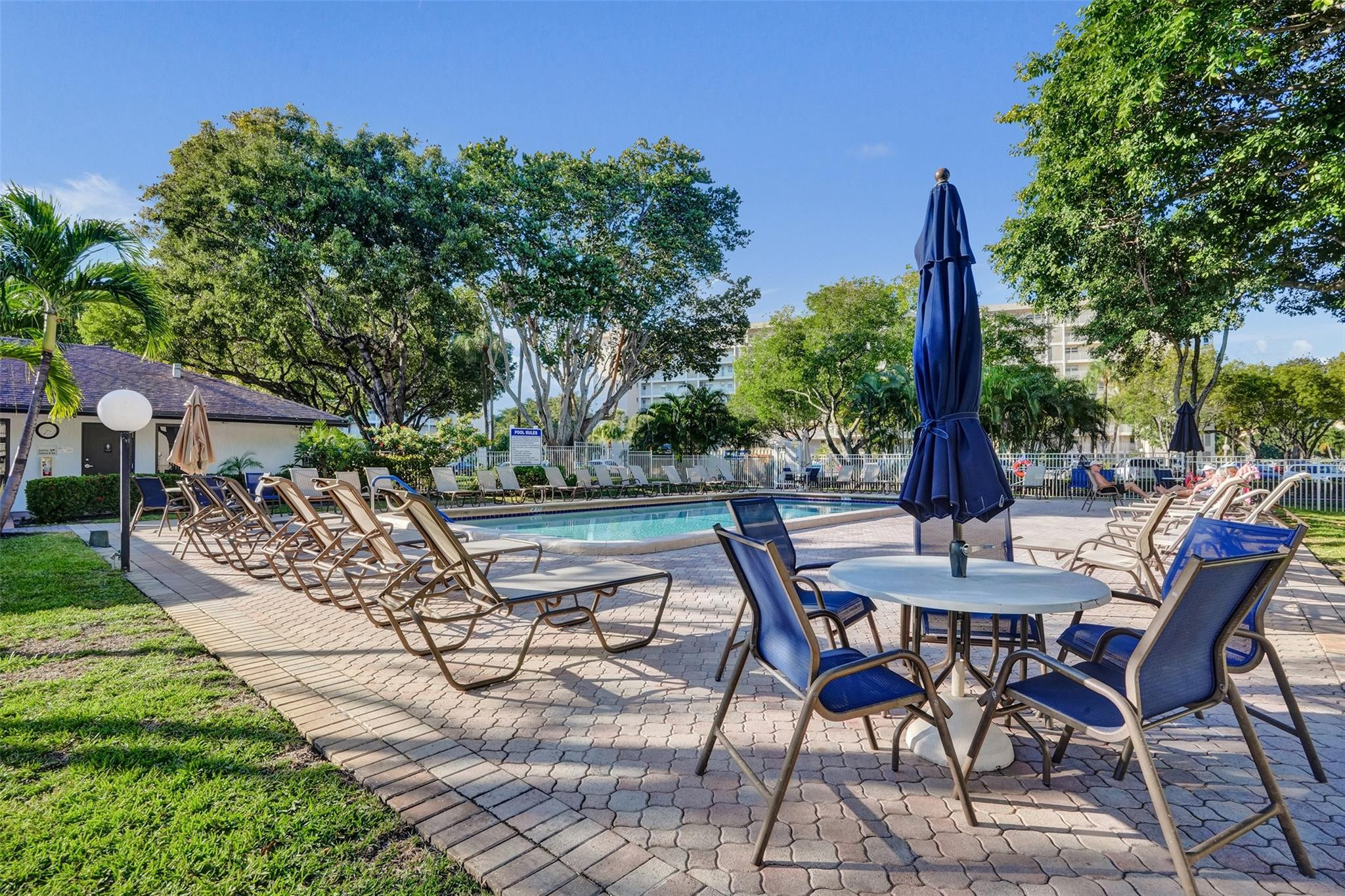 3001 South Course Drive, Unit 107 Pompano Beach, FL 33069 - Photo 42 of 47 a view of a chairs and table on the garden