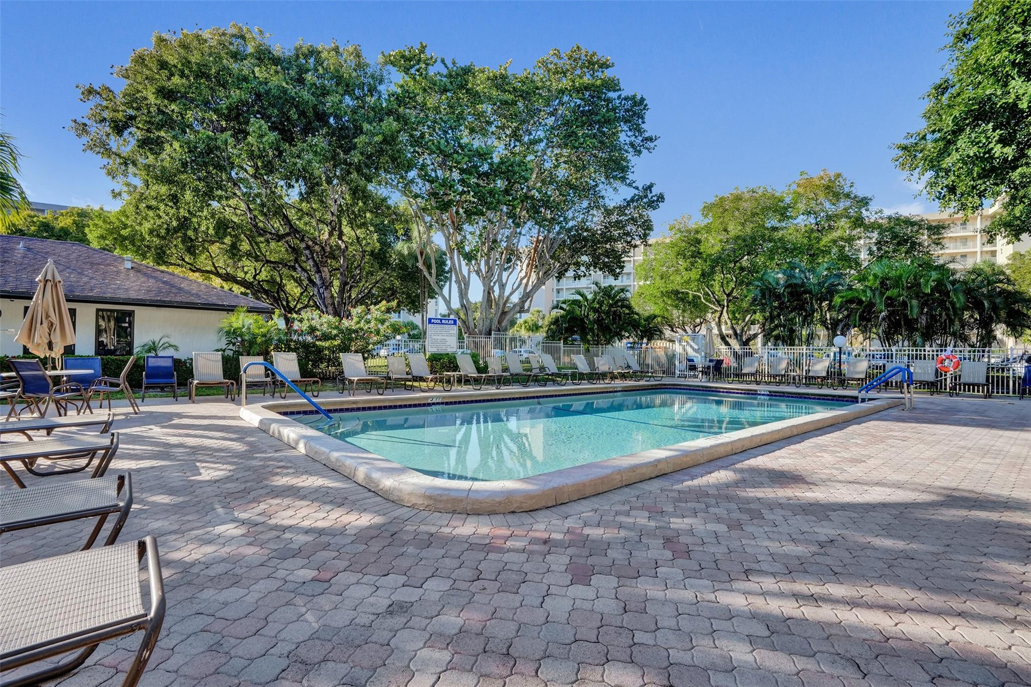 3001 South Course Drive, Unit 107 Pompano Beach, FL 33069 - Photo 43 of 47 a view of a swimming pool with a patio