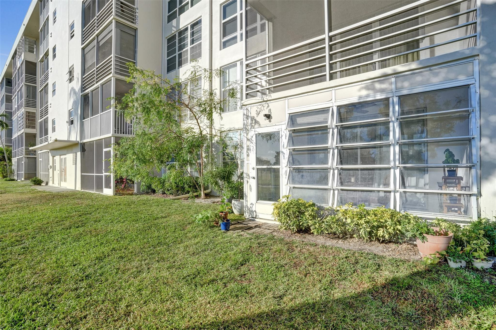 3001 South Course Drive, Unit 107 Pompano Beach, FL 33069 - Photo 45 of 47 a house view with a garden space