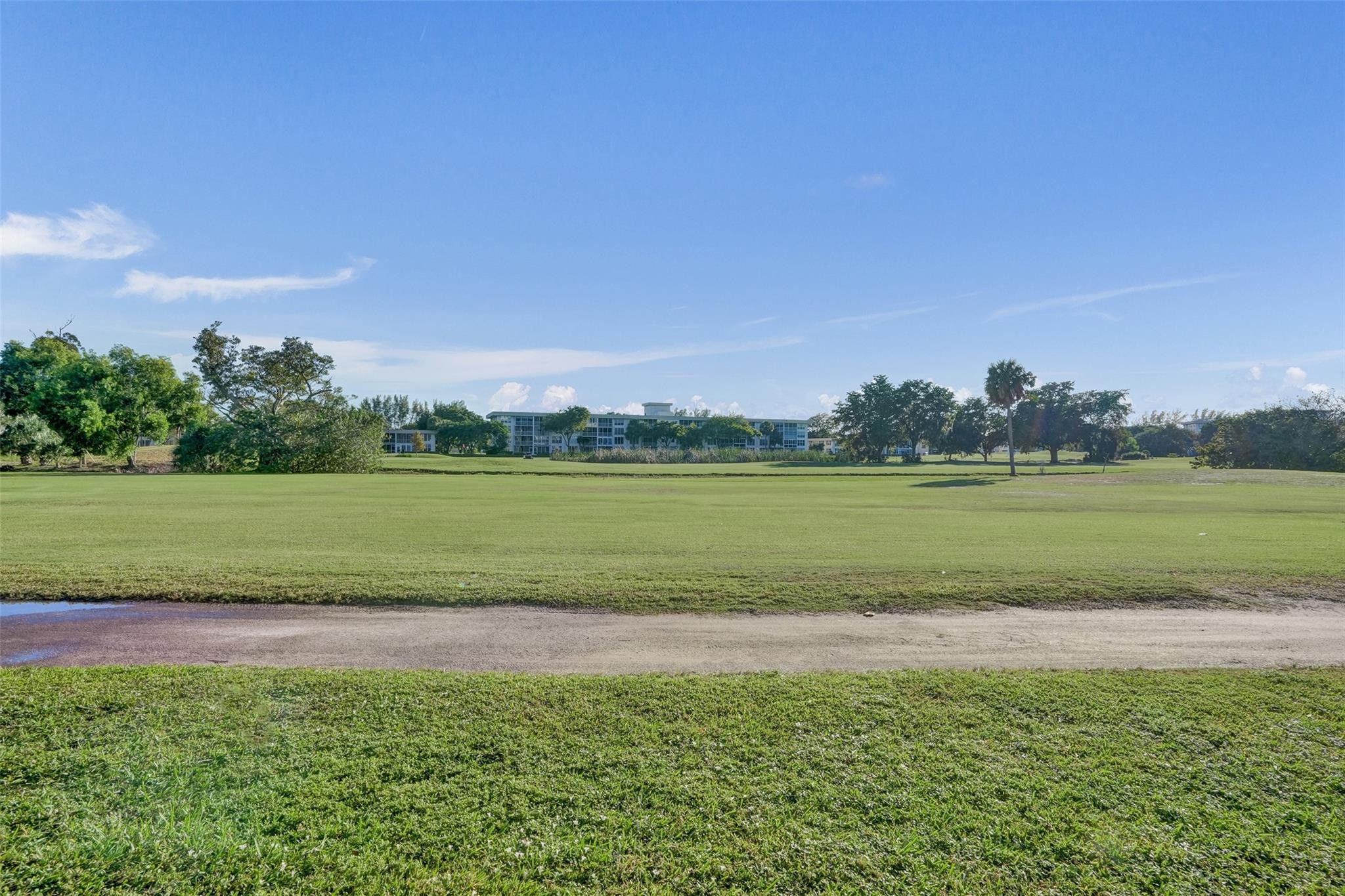 3001 South Course Drive, Unit 107 Pompano Beach, FL 33069 - Photo 46 of 47 a view of a golf course with a lake