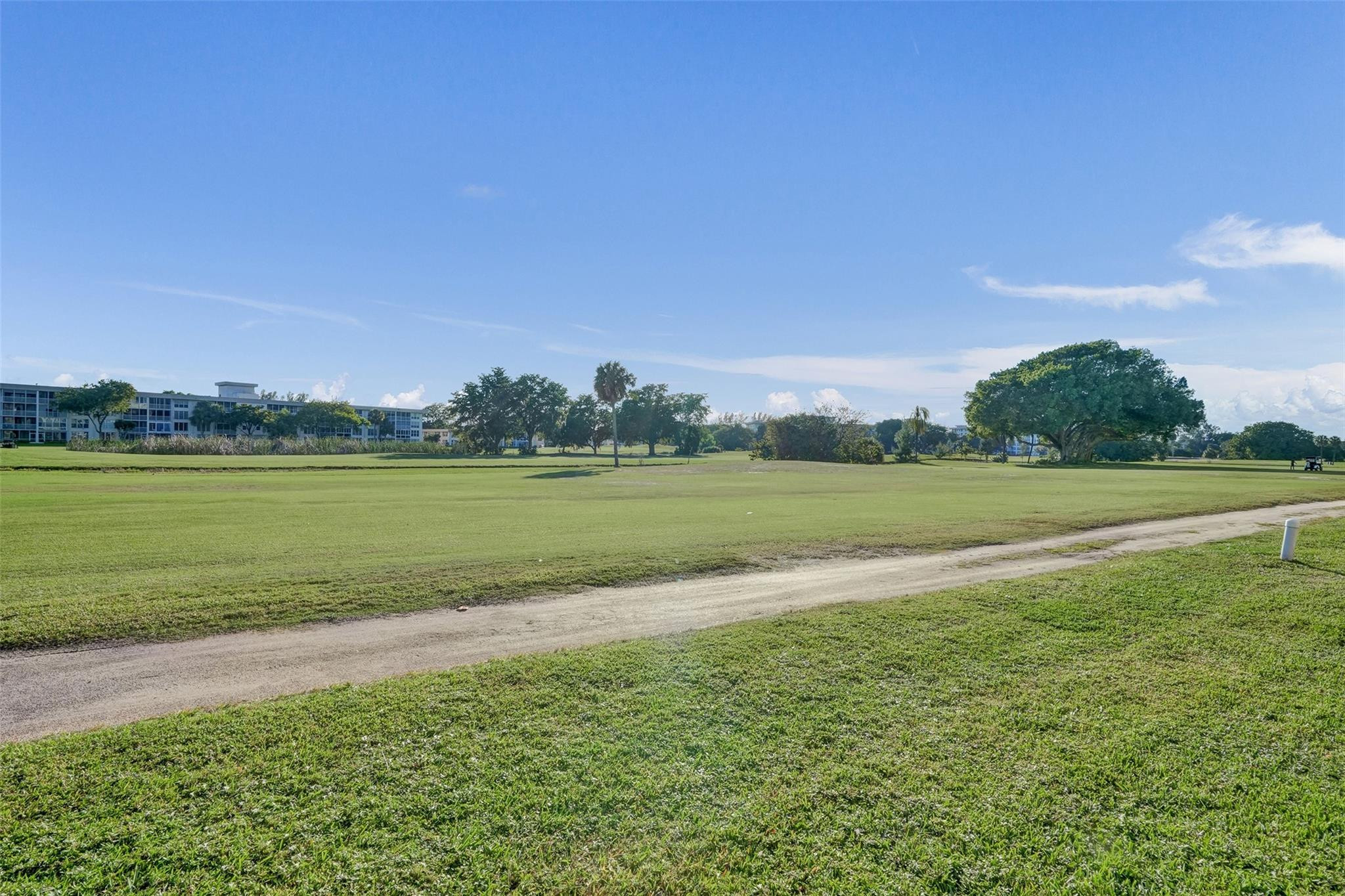 3001 South Course Drive, Unit 107 Pompano Beach, FL 33069 - Photo 47 of 47 a view of a lake with houses in the background
