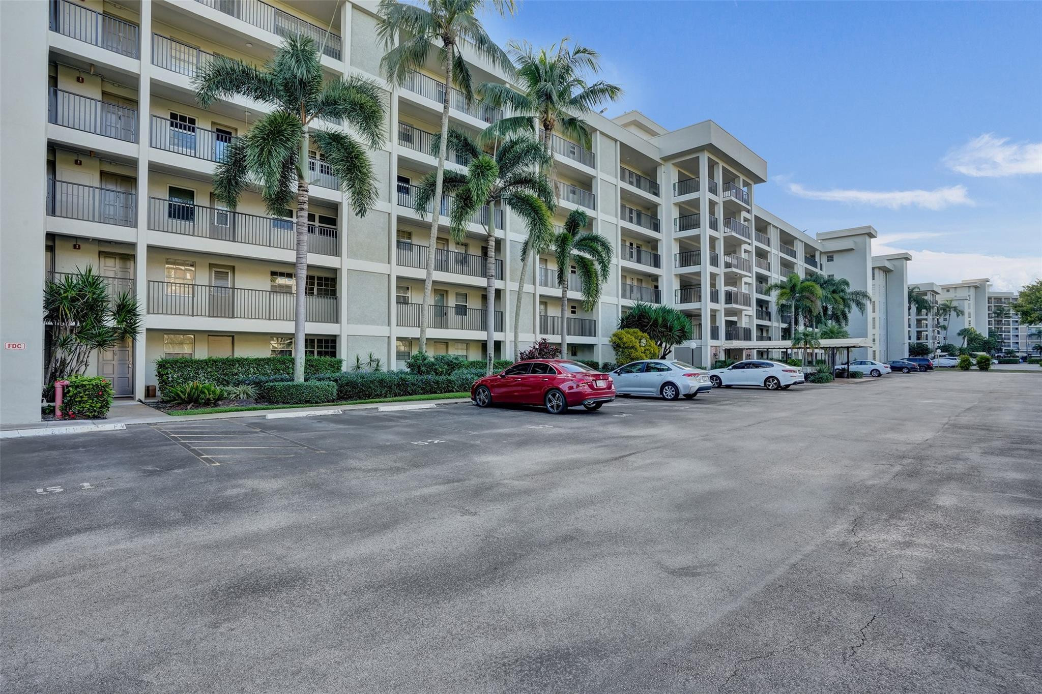 3001 South Course Drive, Unit 107 Pompano Beach, FL 33069 - Photo 7 of 47 a buildings with car parked in front of it
