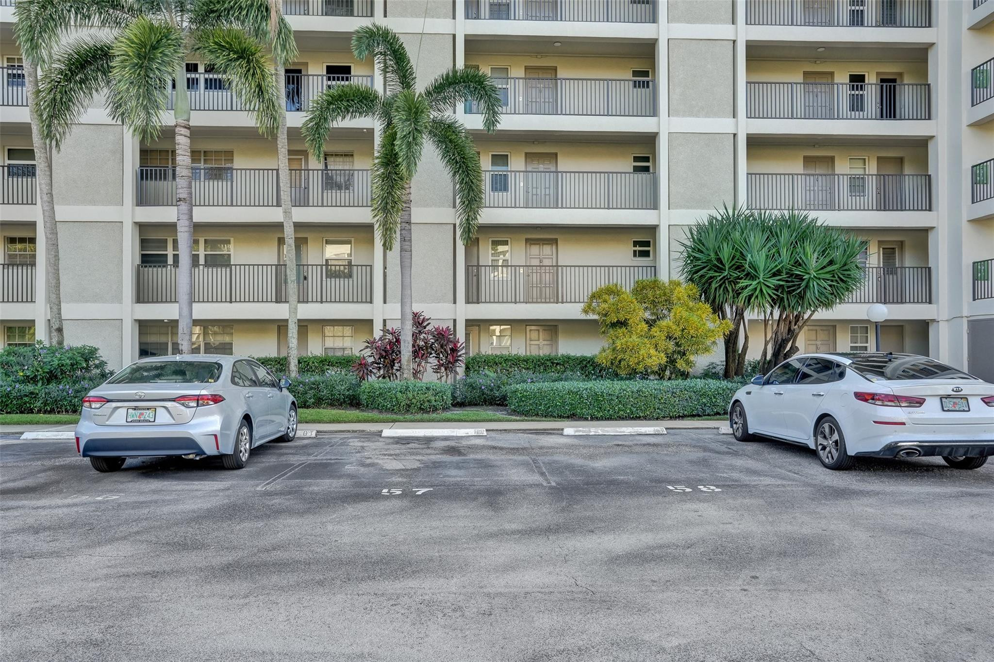 3001 South Course Drive, Unit 107 Pompano Beach, FL 33069 - Photo 8 of 47 a car parked in front of a building