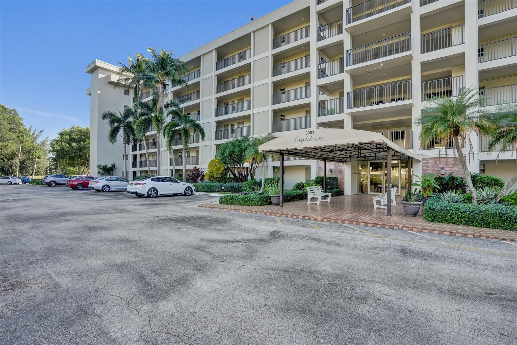 3001 South Course Drive, Unit 107 Pompano Beach, FL 33069 - Photo 9 of 47 a view of a building with a street and sitting area