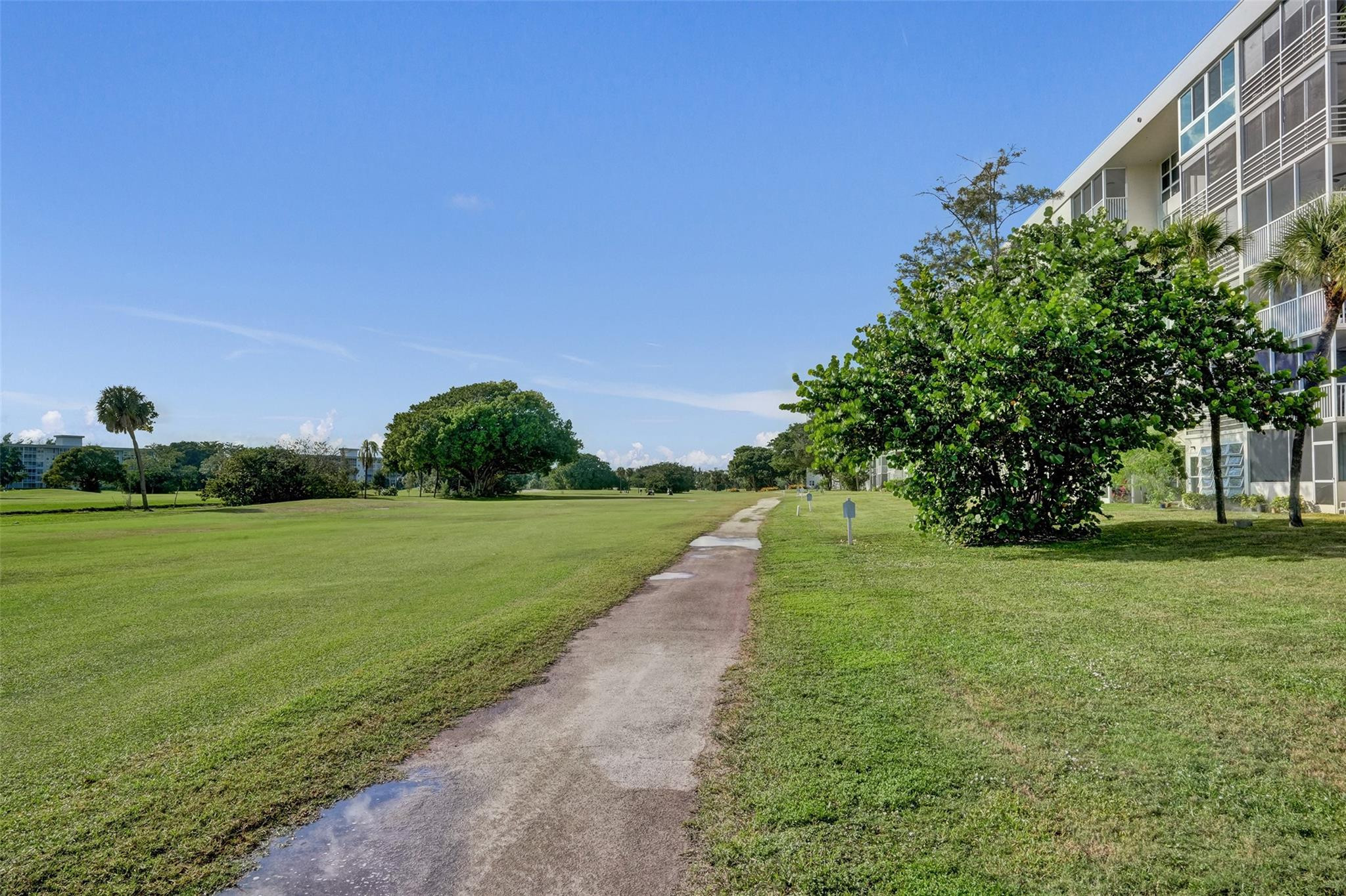 3001 South Course Drive, Unit 107 Pompano Beach, FL 33069 - Photo 10 of 47 a view of a field of grass and trees