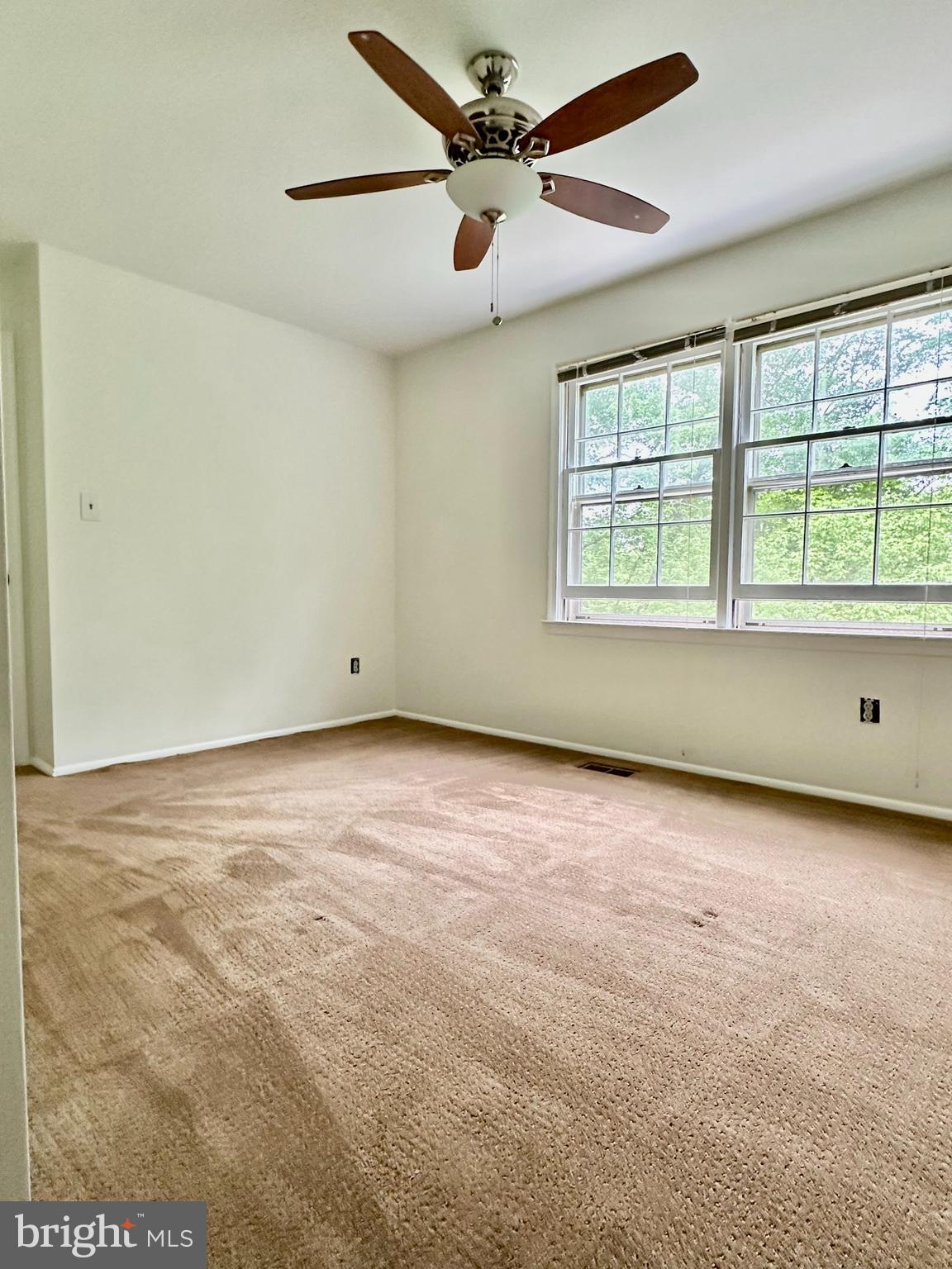 5230 Lonsdale Drive Springfield, VA 22151 - Photo 14 of 25 an empty room with a window and a ceiling fan