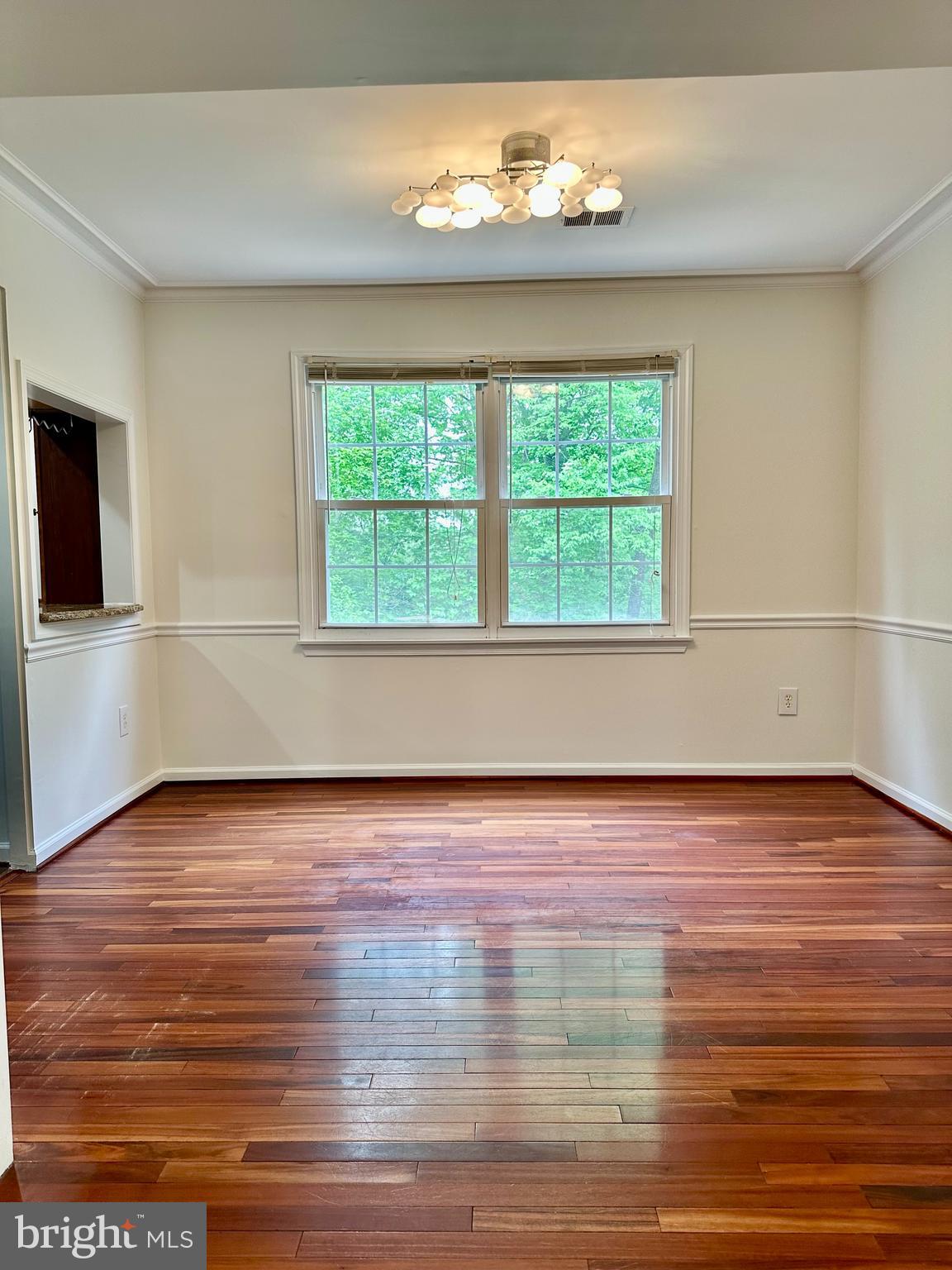 5230 Lonsdale Drive Springfield, VA 22151 - Photo 5 of 25 a view of an empty room with wooden floor and a window