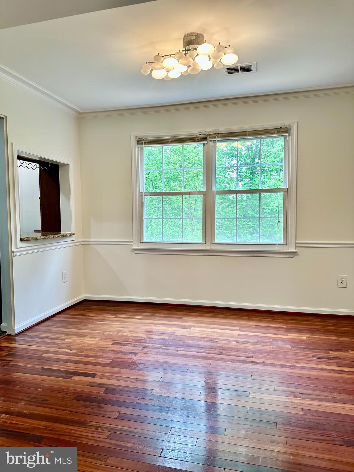 5230 Lonsdale Drive Springfield, VA 22151 - Photo 6 of 25 an empty room with wooden floor and windows