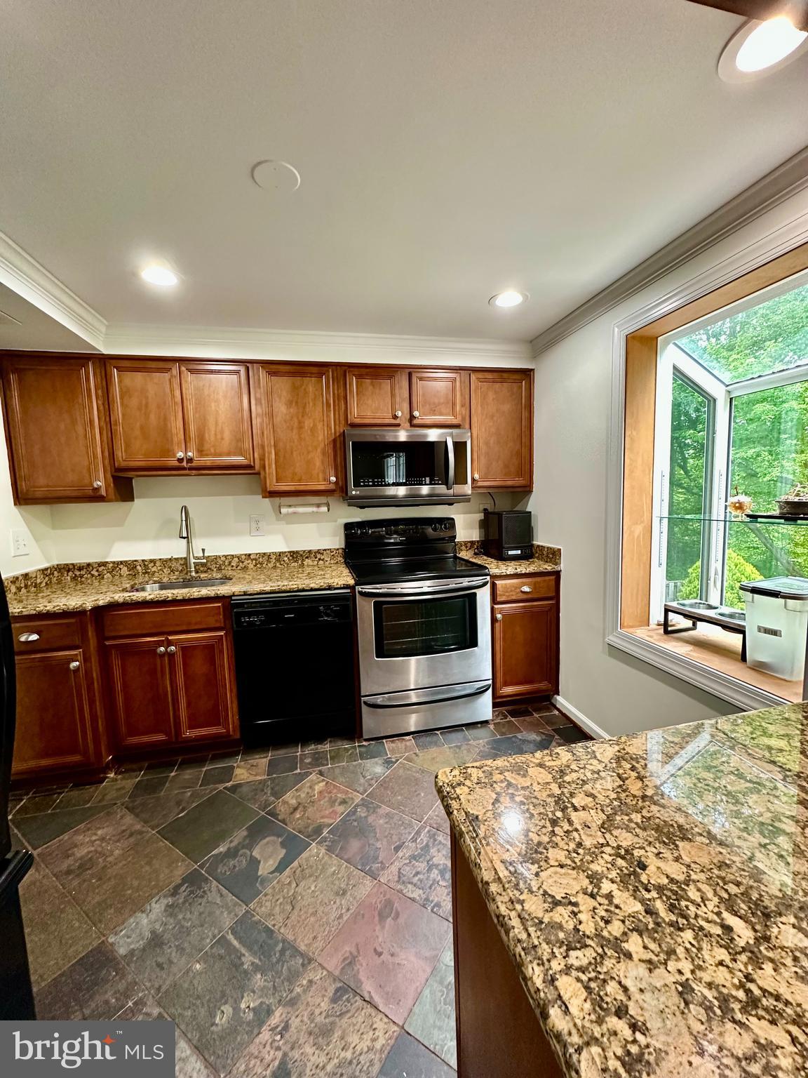 5230 Lonsdale Drive Springfield, VA 22151 - Photo 7 of 25 a kitchen with stainless steel appliances granite countertop a stove sink and cabinets