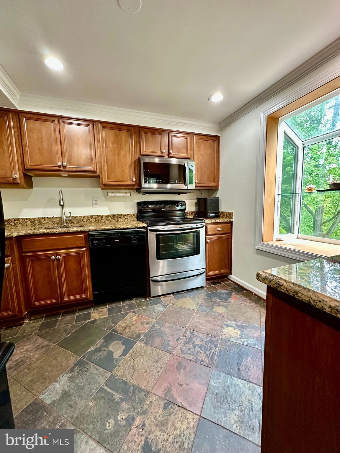 5230 Lonsdale Drive Springfield, VA 22151 - Photo 8 of 25 a kitchen with stainless steel appliances granite countertop a stove sink and cabinets