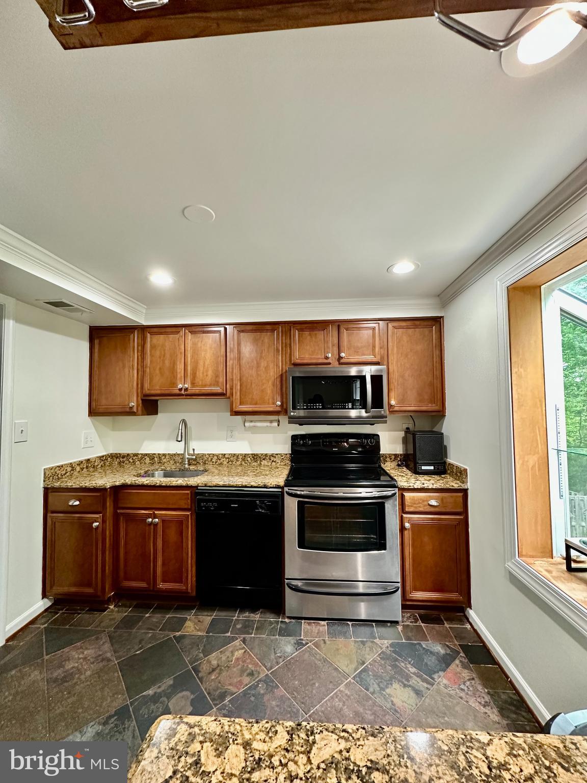 5230 Lonsdale Drive Springfield, VA 22151 - Photo 9 of 25 a kitchen with stainless steel appliances granite countertop a stove sink and cabinets