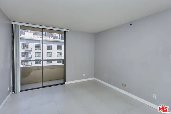 an empty room with sliding glass door