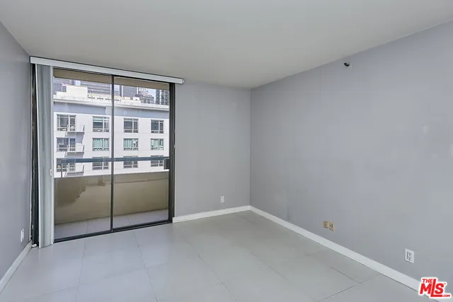 an empty room with sliding glass door