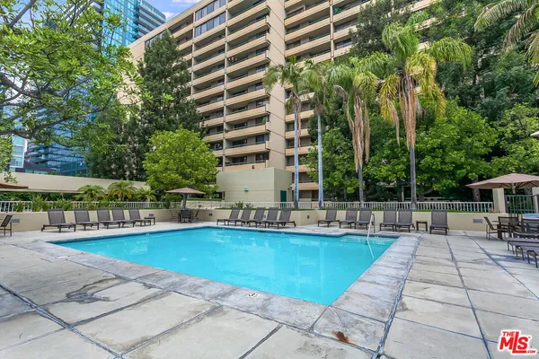 a view of swimming pool with outdoor seating and plants