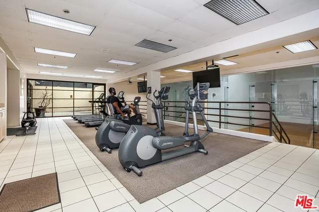 a room with gym equipment and view of living room
