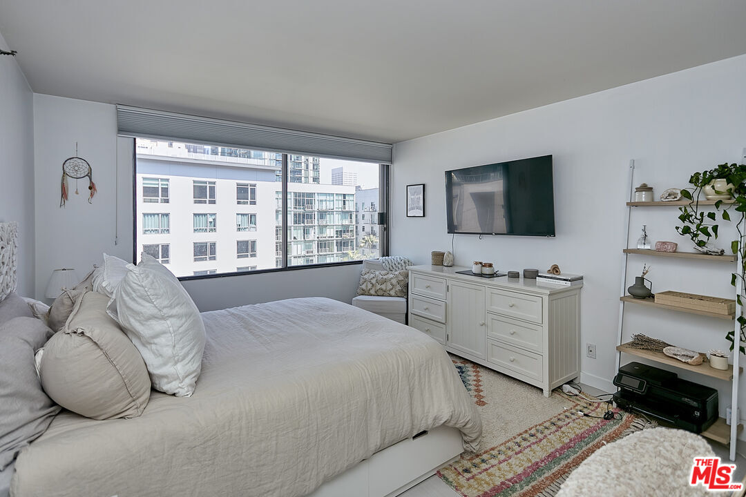 600 West 9th Street, Unit 805 Los Angeles, CA 90015 - Photo 8 of 28 a bedroom with a bed and a flat tv screen on dresser