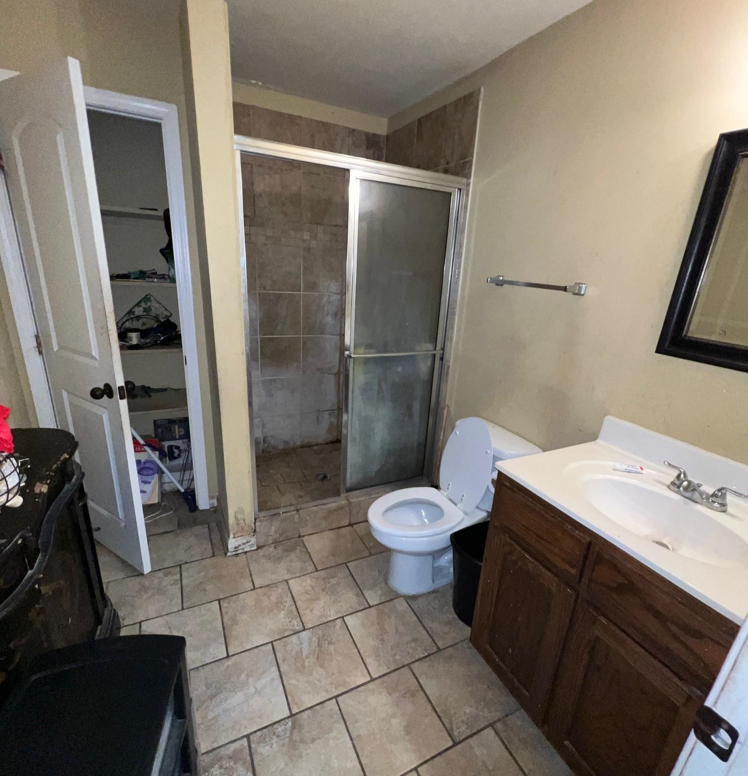 3784 McCain Road Memphis, TN 38109 - Photo 8 of 14 Bathroom featuring a glass-enclosed shower, single vanity with integrated sink, tile flooring, and a built-in storage closet