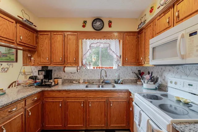 a kitchen with sink refrigerator and cabinets