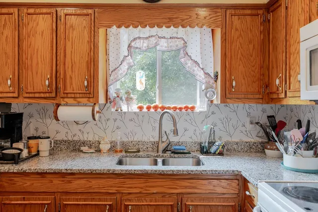 a kitchen with a sink stove and cabinets