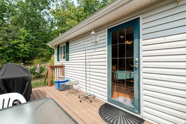 a view of balcony with wooden floor and outdoor seating