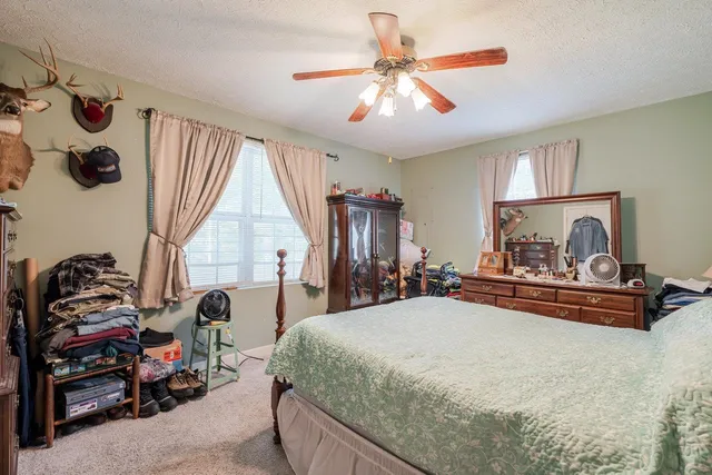 a bedroom with bed and window