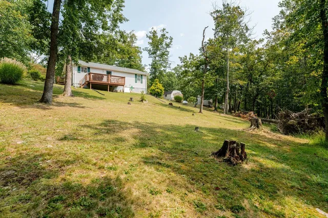 a house view with swimming pool in front of it