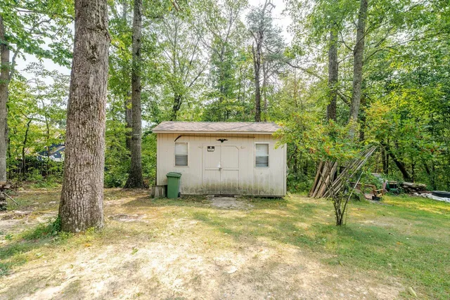 a view of house with swimming pool and garden