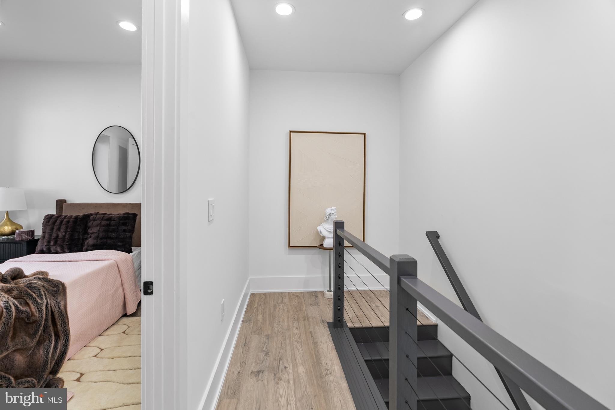 1140 Oates Street Northeast, Unit 101 Washington, DC 20002 - Photo 12 of 34 a bed room with a bed and a chandelier