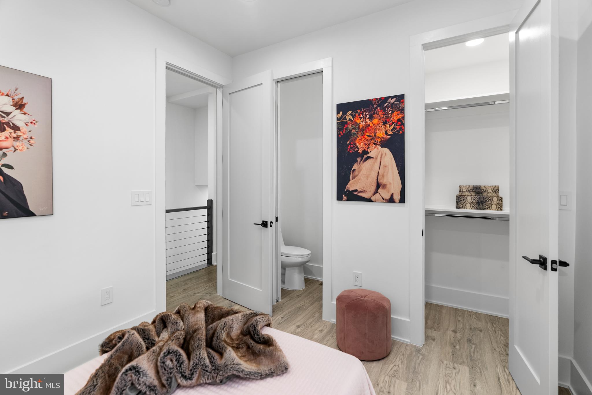 1140 Oates Street Northeast, Unit 101 Washington, DC 20002 - Photo 14 of 34 a bedroom with furniture and a painting