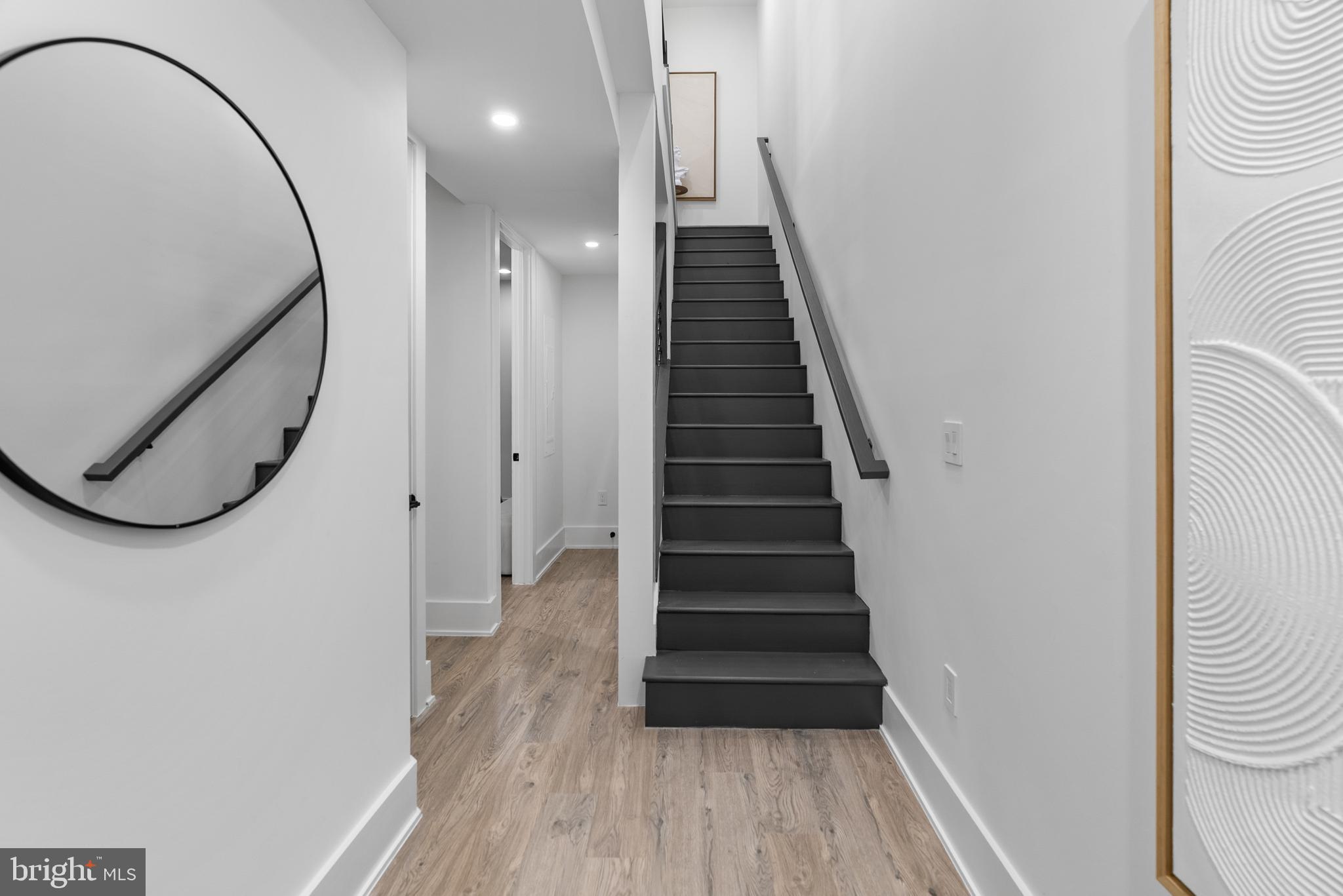 1140 Oates Street Northeast, Unit 101 Washington, DC 20002 - Photo 17 of 34 a view of a hallway with wooden floor and staircase