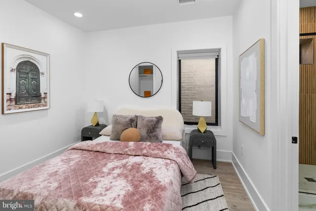 a bedroom with a large bed and a chandelier