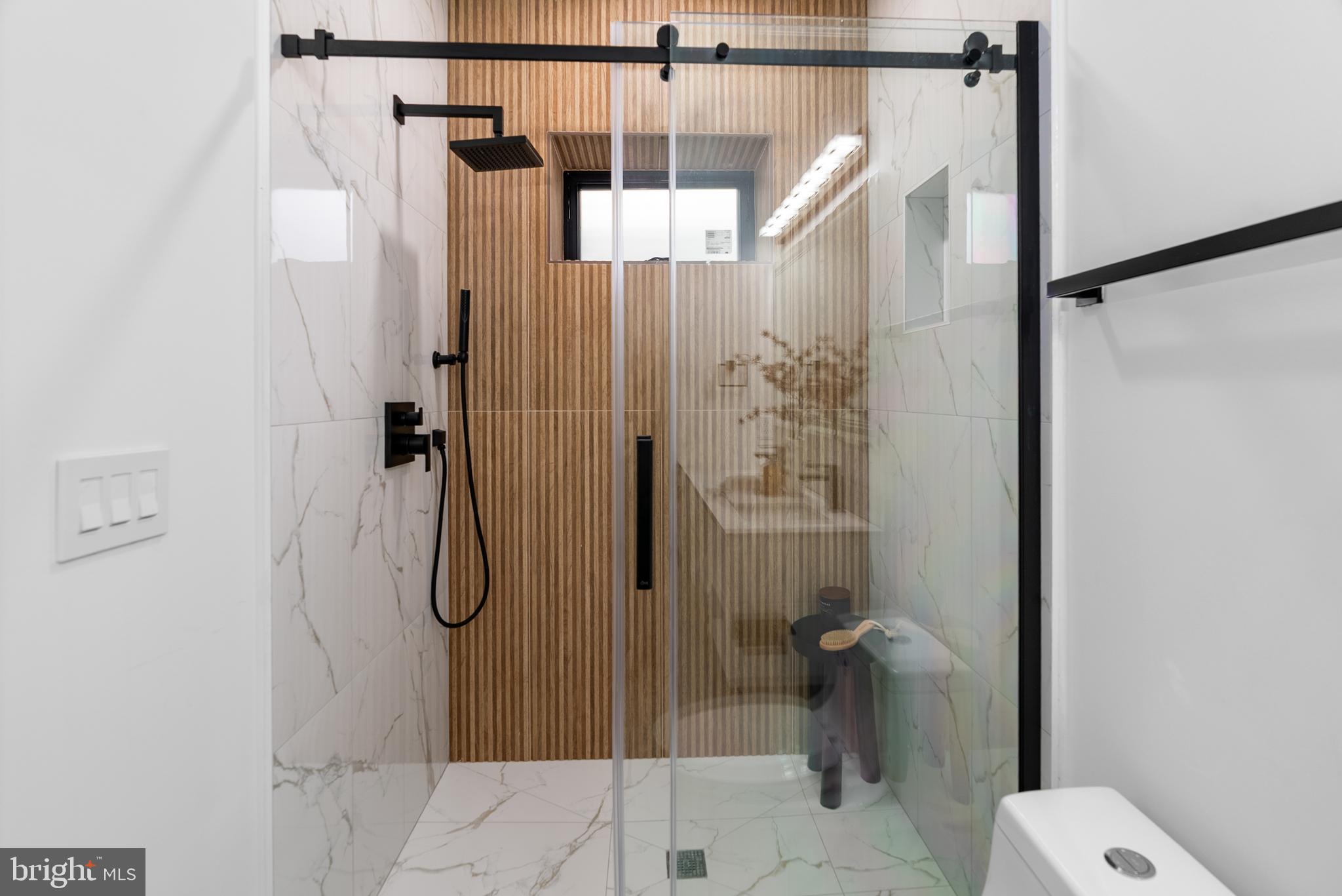 1140 Oates Street Northeast, Unit 101 Washington, DC 20002 - Photo 23 of 34 a bathroom with a shower and toilet