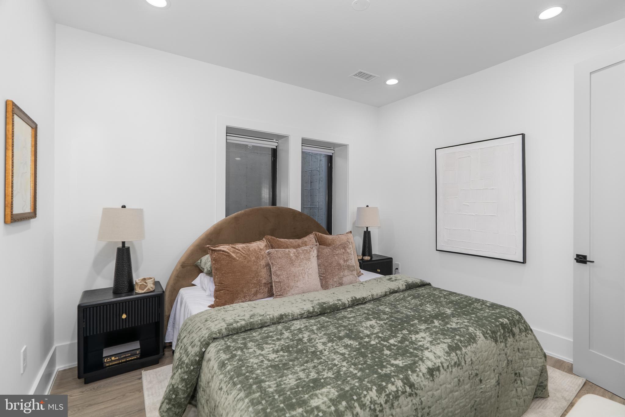 1140 Oates Street Northeast, Unit 101 Washington, DC 20002 - Photo 24 of 34 a bedroom with a bed and night stand