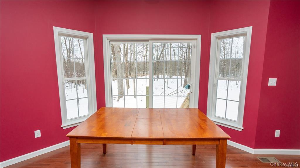 5 Harrier Ridge Drive Wallkill, NY 12589 - Photo 6 of 33 Dining space with healthy amount of natural light and dark wood finished floors
