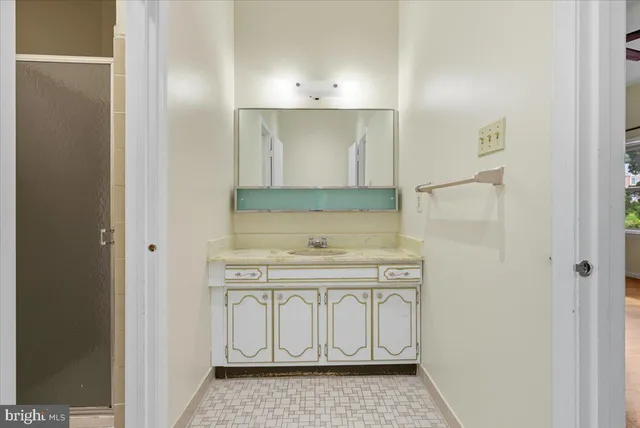 a bathroom with a sink a vanity and a mirror